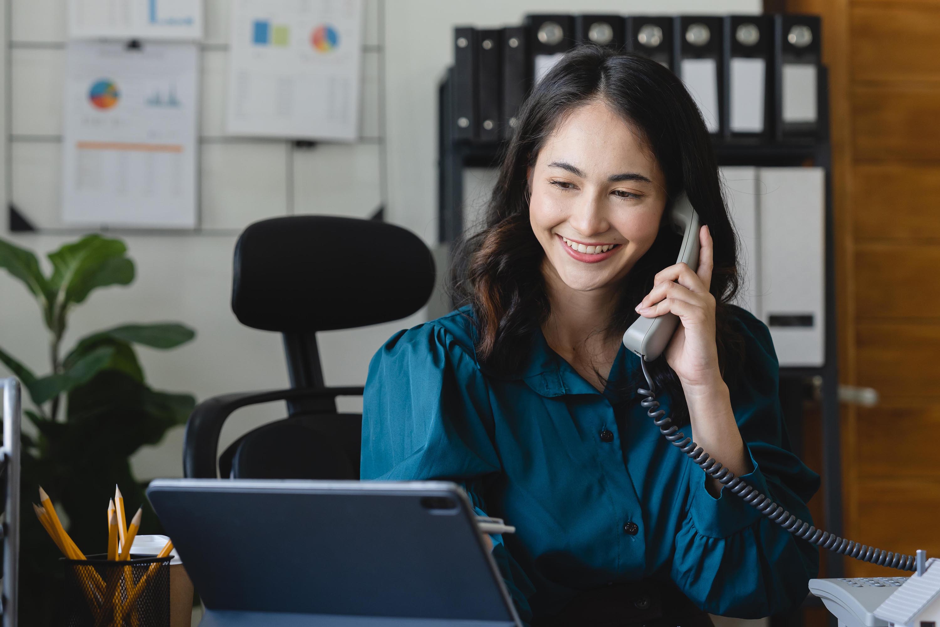 Young lady talking on a landline phone