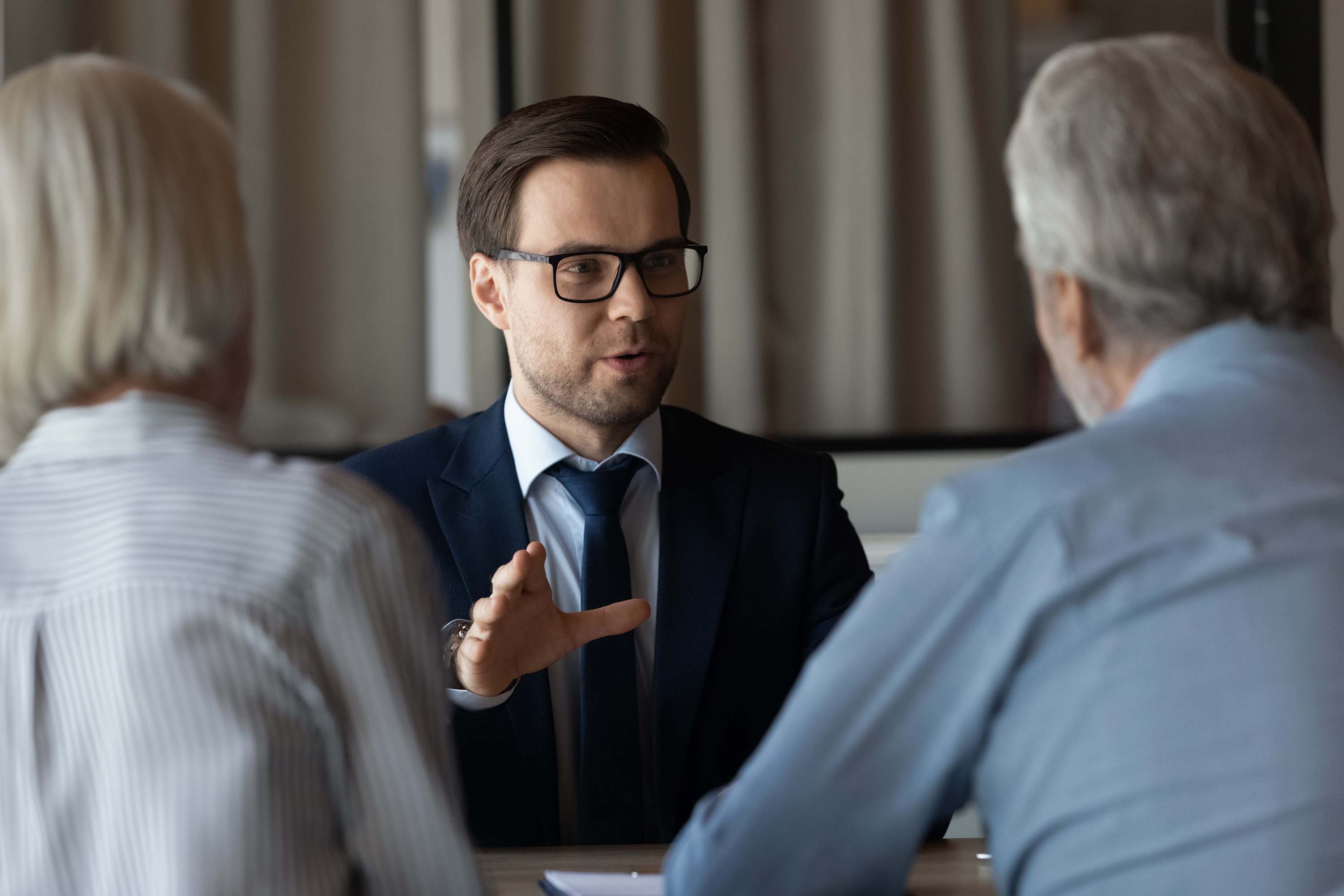 An agent talking with a senior couple 