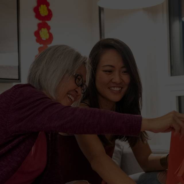 Mother showing a red lantern to her daughter