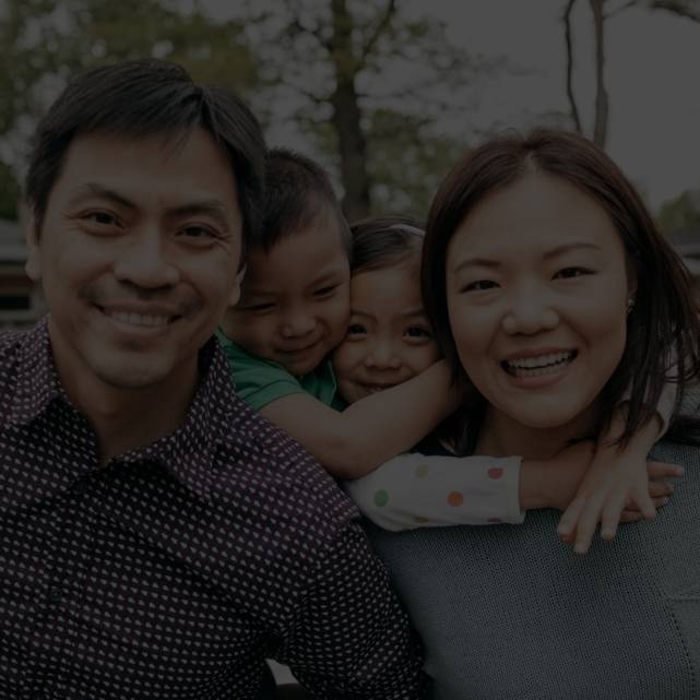 An asian family of four with the parents and two kids