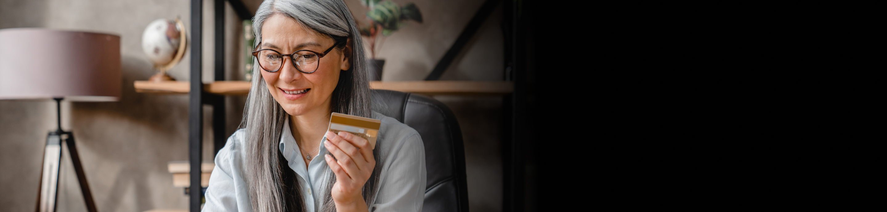 A senior lady holidling a credit card 