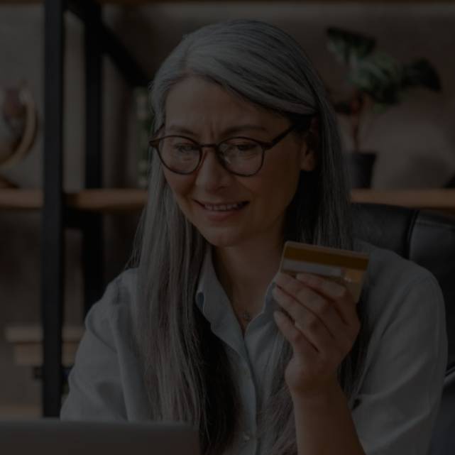 A senior lady holidling a credit card 