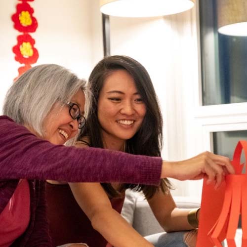 Chinese mother and daughter making Chinese New Year decoration