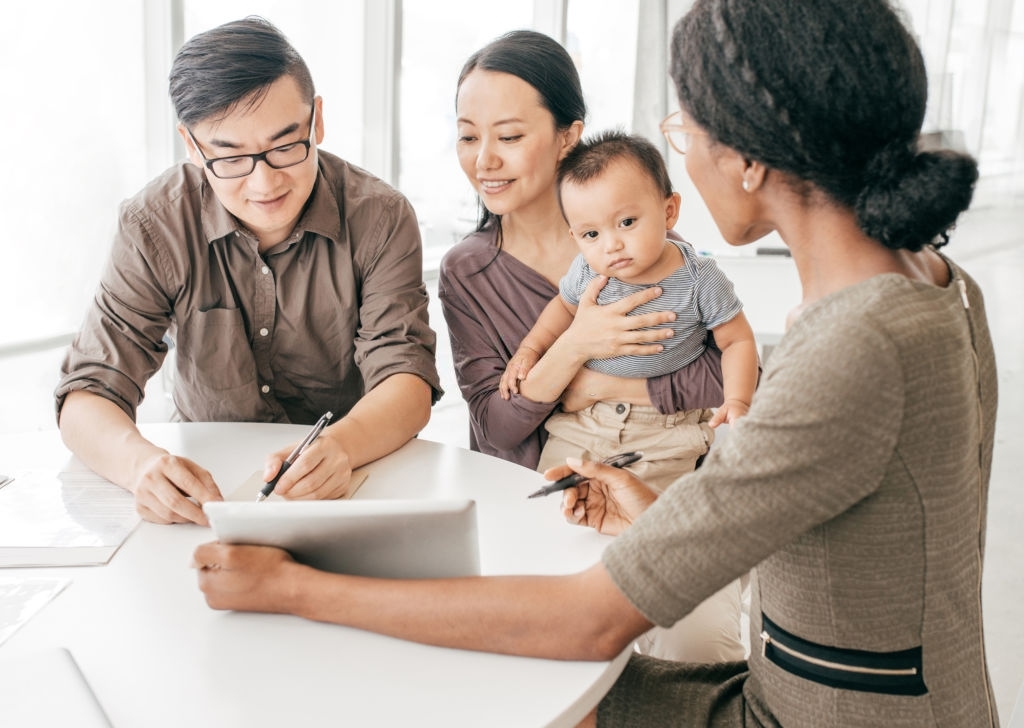 A young family of three talking to a financial advisor